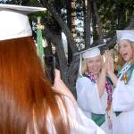 Port Angeles High School senior Rachel Hendry, left, takes a photo of classmates Christine Beirne and Charlotte Hertel at Erickson Playfield prior to Fridays commencement ceremony at nearby Civic Field. More than 230 students were scheduled to become part of the Class of 2019. (Keith Thorpe/Peninsula Daily News)