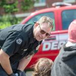 Port Angeles Firefighter Daniel Montana talks to people at Veterans Memorial Park. (Jesse Major/Peninsula Daily News)
