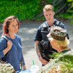 Community Change Agent Amy Miller, of the REdisCOVERY program, and Officer Jackson VanDusen talk with a a homeless veteran at Veterans Memorial Park. (Jesse Major/Peninsula Daily News)