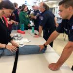 East Jefferson Fire-Rescue team member Pete Yelaca teaches how to apply a tourniquet during the Chimacum School Districts Stop the Bleed training Monday. (East Jefferson Fire Rescue)