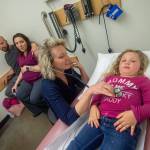 Dr. Jessica Colwell examines Azila Black, 3, as her parents Ryan and Amber Black look on at North Olympic Healthcare Network. (Jesse Major/Peninsula Daily News)