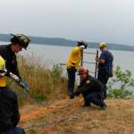 Firefighters work to rescue a 90-year-old man from a cliff side on Marrowstone Island. (East Jefferson Fire-Rescue)