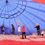 The hot air balloons were grounded at Airport Appreciation Day at Fairchild International Airport because of the weather, so organizers turned an older balloon into an inside-out bounce house. Children played inside the half-inflated balloon with beach balls while enjoying the steady stream of air being forced into the canopy to keep it partially inflated. (Dave Logan/for Peninsula Daily News)