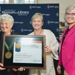 Accepting the award for the Jamestown SKlallam Tribal Library are, from left, Liz Mueller, tribal council vice chair; and Celeste Dybeck, tribal elder. To the right is Kathryn Kit Matthew, director of the Institute of Museum and Library Services.