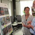 Phillipa Nye of Ally Community Development discusses several options for the Olympic Community Action Programs proposed 44-unit housing complex with Roy Walker of the Olympic Area Agency on Aging. About 50 people attended an open house Wednesday night in the Dirksen conference room at Jefferson Healthcare. (Brian McLean/Peninsula Daily News)