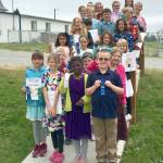 The winners of Olympic Christian Schools Young Authors festival hold up their awards.