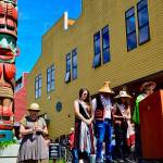 Elaine Grinnell blesses the new totem pole at the Northwest Maritime Center in Port Townsend as part of an opening ceremony for the Chetzemoka Trail. (James Cook/for Peninsula Daily News)