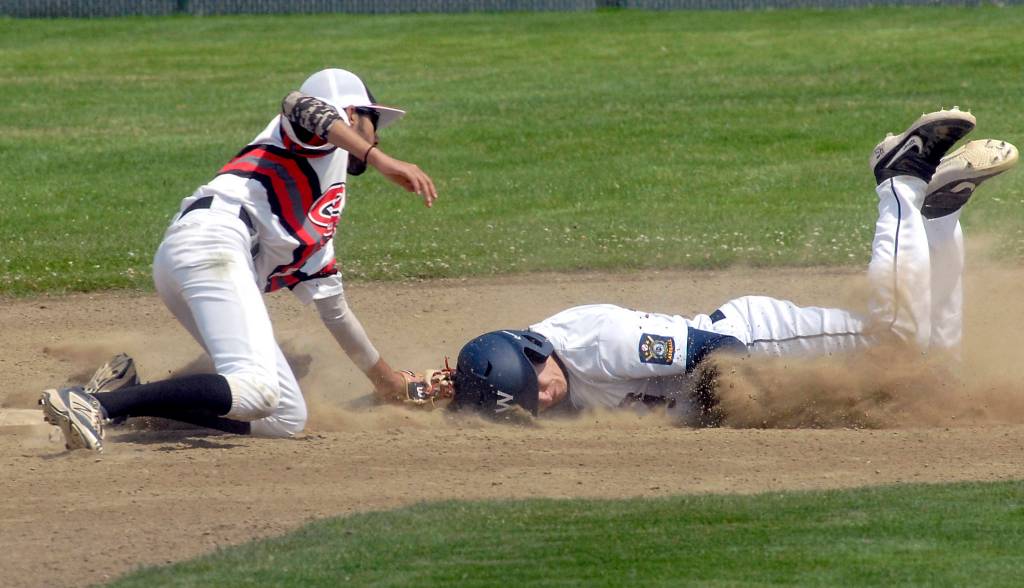 <strong>Keith Thorpe</strong>/Peninsula Daily News                                Wilder Juniors Kamron Meadows, right, slides head-first into second as Australia White shortstop Amrik Singh tags him out at Volunteer Field in Port Angeles. Meadows later made a diving, run-saving grab in center field in the nightcap of Wilders doubleheader.