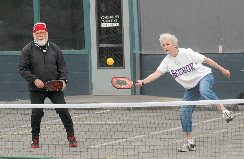 Jay Boggess left, and Nita Davidson, both of Port Angeles, take part in a pickleball tournament at The Landing mall, part of Thursdays Independence Day celebration in Port Angeles. (Keith Thorpe/Peninsula Daily News)