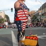Andrea Donisi, along with her hot dog, Myer, marches with the Port Angeles Lefties parade entry on the Fourth of July. (Keith Thorpe/Peninsula Daily News)