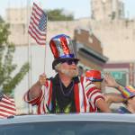 Rick Goette, owner of the New Moon Craft Tavern, shows patriotic spirt from from his businesss parade entry. (Keith Thorpe/Peninsula Daily News)
