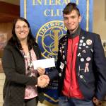 Rotary Club President Jayne Neu, left, accepts a check from Interact club member Kuba Krol, a foreign exchange student from Poland, for the Rwandan Grandmas organization.