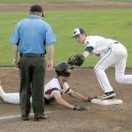 Keith Thorpe/Peninsula Daily News Wilder third baseman Wyatt Hall, right, forces out Austrailia Reds Matthew Rheaume in the fourth inning of their Saturday game in the Dick Brown Memorial Tournament at Port Angeles Civic Field.