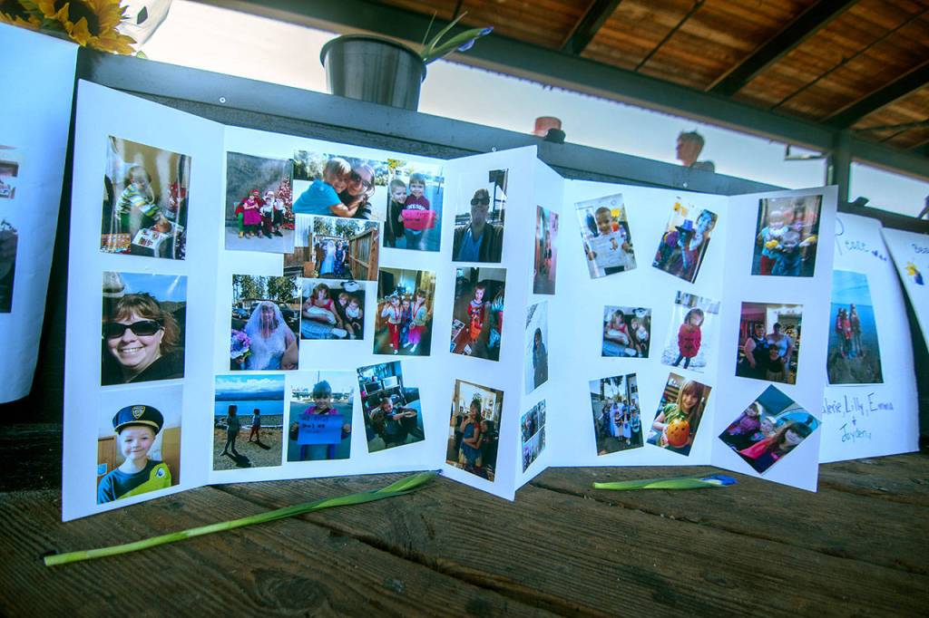 Photos of Valerie Kambeitz and her children Lilly, Emma and Jayden Kambeitz during a vigil in their honor Monday. (Jesse Major/Peninsula Daily News)
