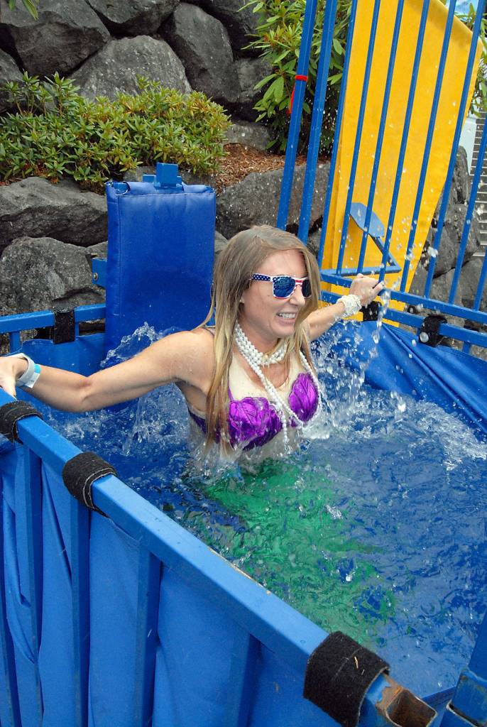 Sara Dutrow of Olympic Veterinary Clinic grimaces after being dropped into a dunk tank Friday night. Proceeds from the dunk tank were to benefit Clallam County fire district volunteers and the Captain Joseph House Foundation. (Keith Thorpe/Peninsula Daily News)
