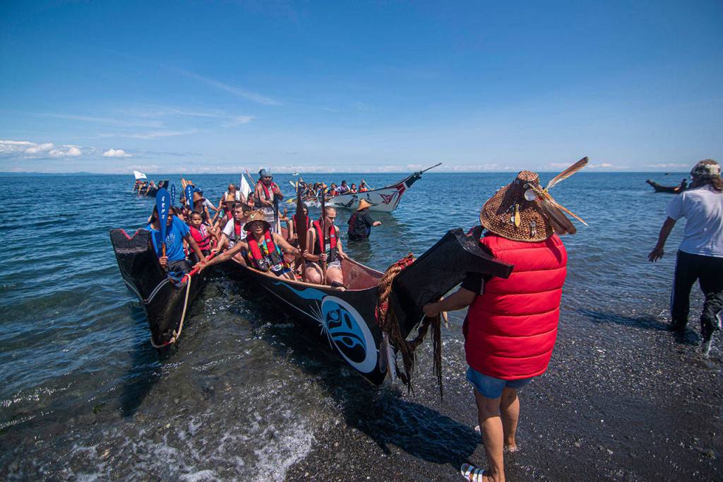Canoes land at the Lower Elwha Klallam Tribes reservation Sunday during the Paddle to Lummi. (Jesse Major/Peninsula Daily News)