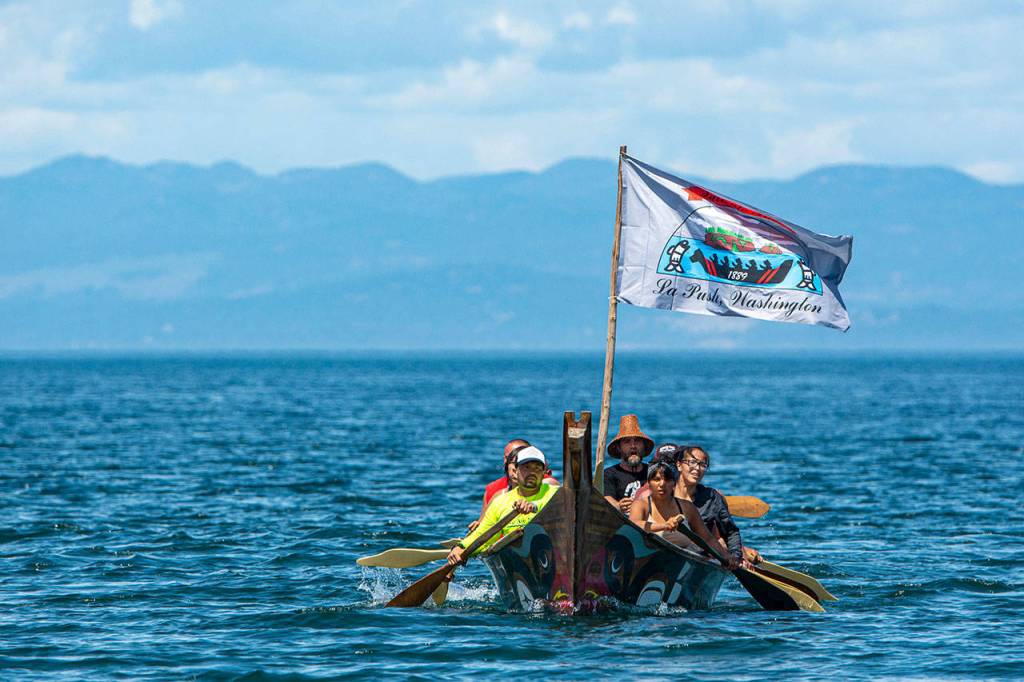 Members of the Quileute Tribe arrive at the Lower Elwha Klallam Tribes reservation during the Paddle to Lummi on Sunday. (Jesse Major/Peninsula Daily News)