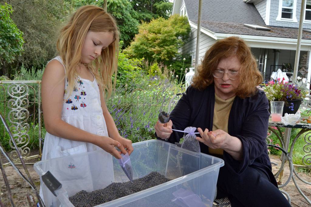 Lucca Schiefen and her grandmother Barbara Brown of San Francisco prepare sachets for a busy weekend of visitors to Jardin du Soleil Lavender Farm. The farm partners with Olympic Lavender Farm to host two festivals for the price of one during Sequim Lavender Weekend. (Matthew Nash/Olympic Peninsula News Group)