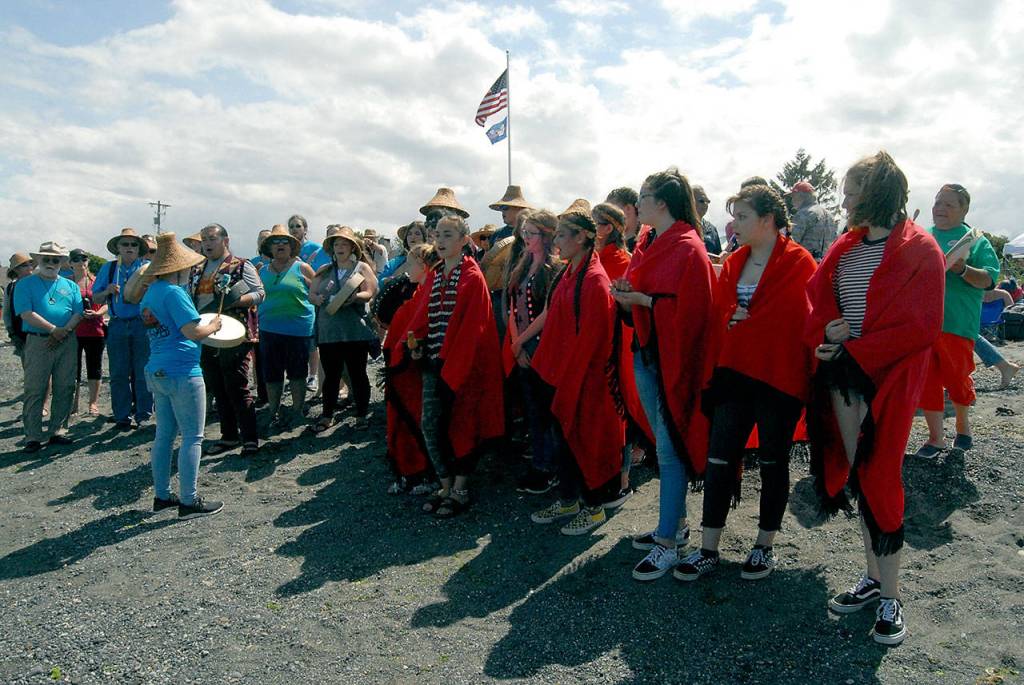 Klallam children sing a welcome song to canoes approaching Jamestown Beach on Tuesday. (Keith Thorpe/Peninsula Daily News)