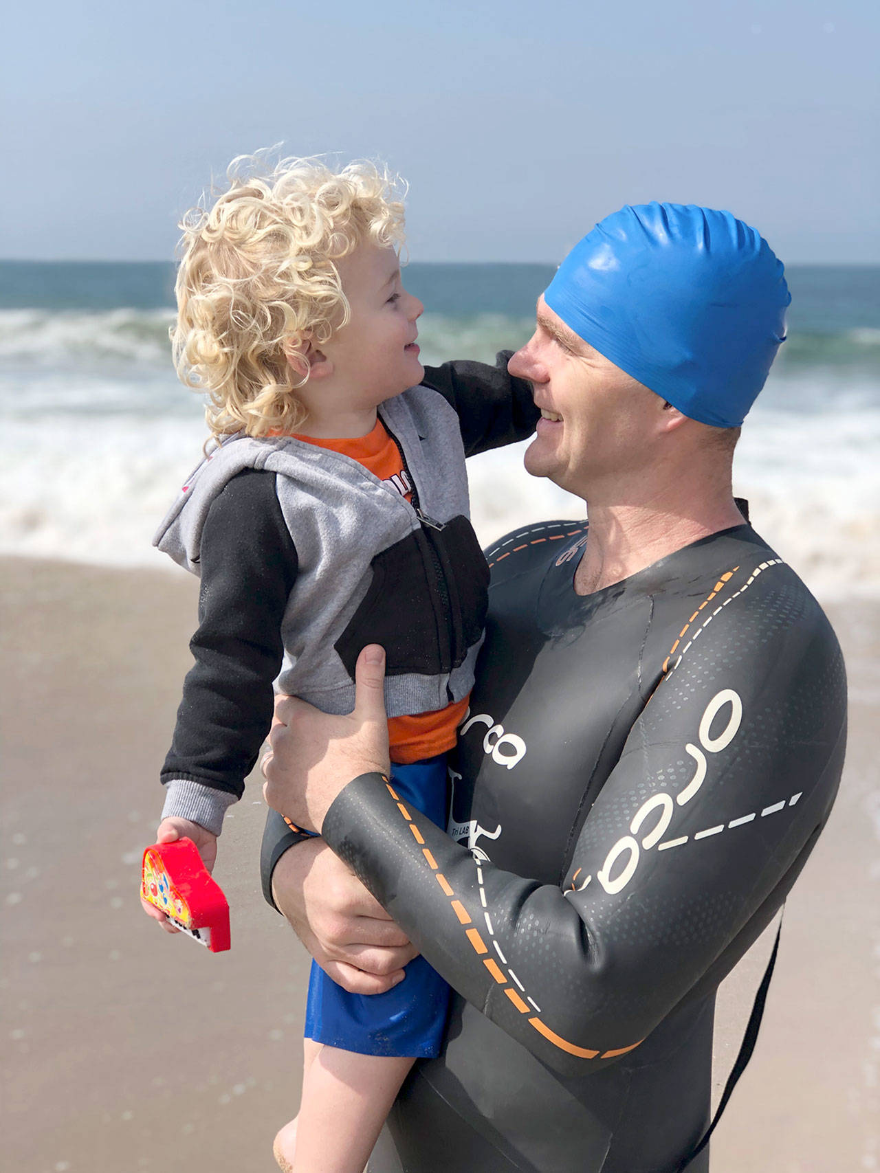 Swimmer Ron DeCou and his son, Hudson, age 2, of Los Angeles enjoy a moment after one of Robs training swims.