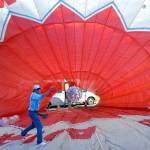 Jeff Terry, crew chief with the Dream Catcher Balloon project, tosses a ball in front of a fan used to inflate a decommissioned hot air balloon set up as a bounce house at the Olympic Lavender farm. (Keith Thorpe/Peninsula Daily News)