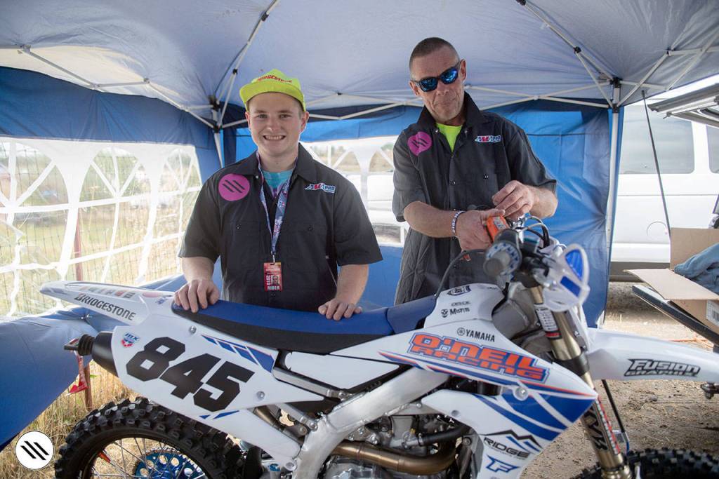 Port Angeles motocross rider Bryan ONeil, left, and his dad, Dennis ONeil, pose with ONeils motorcycle before a race.