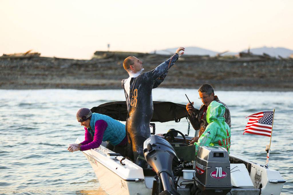 Rob DeCou and his crew head out to his starting point at Dungeness Spit for his attempt to swim across the Strait of Juan de Fuca on Saturday. (Luke Rafferty)