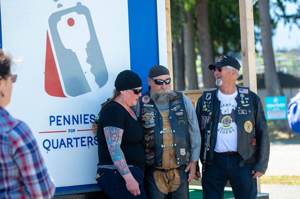 Kelly Cook, Bob Glaves, center, and Clallam County Veterans Association President Gary Velie pose for photos in Port Angeles before starting a motorcycle ride Sunday. Glaves, a terminally ill Vietnam War veteran, is on his way to Washington, D.C., to see the Vietnam Veterans Memorial. (Jesse Major/Peninsula Daily News)