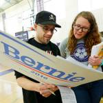 In this March 26, 2016, file photo, Stuart Huntoon, left, and Stephanie Edmisson hold a sign supporting Democratic presidential candidate Sen. Bernie Sanders as they attend a precinct group during a Democratic caucus at Garfield High School in Seattle. (Ted S. Warren/The Associated Press, File)