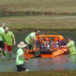 Keith Thorpe/Peninsula Daily News An unlimited class boat driven by Dean Lautenschlager and navigated by Jack Brusman is pushed back into the water after running aground on Saturday.