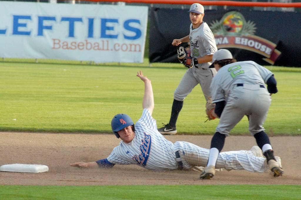 Keith Thorpe/Peninsula Daily News                                Lefties outfielder Rhyse De-Hyden makes an unsuccessful dive into second after being tagged out by Portland short stop Kyle Velazquiz as his teammate Austin Lively looks on during the second inning on Friday night in Port Angeles.