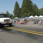 A tanker truck belonging to Clallam Count Fire District 4 sprays water down the parade route on State Highway 112.