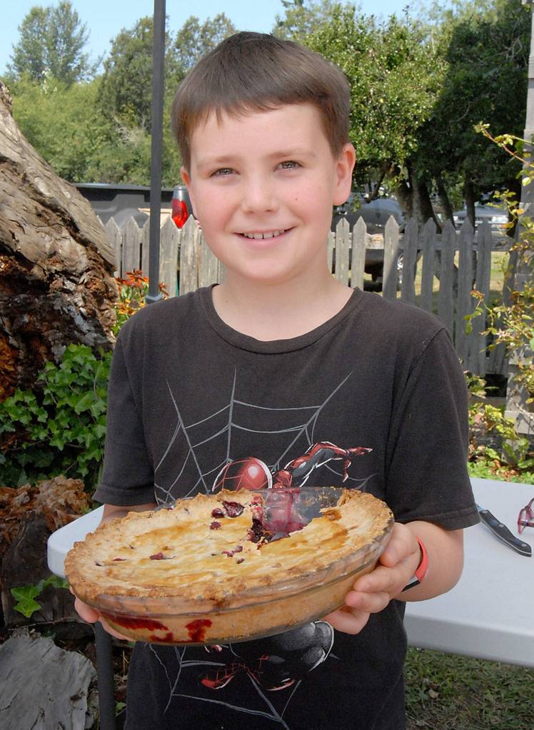 Blackberry pie contest youth catagory winner Nick Ellison of Lewes, England displays his creation after judging.