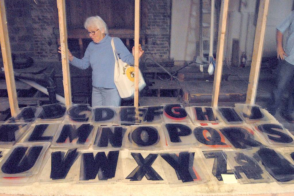 Peggy Norris looks over a collection of marquee letters stored in the balcony of the Lincoln Theater. (Keith Thorpe/Peninsula Daily News)