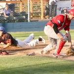 Dave Logan/for Peninsula Daily News Port Angeles Brad Altomarie slides into home safely as Victoria catcher Tyson Hays juggles the throw from the outfield.