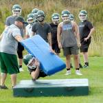 Keith Thorpe/Peninsula Daily News Port Angeles head football coach Troy Mann leads the team through tackling drills during a preseason practice Friday.