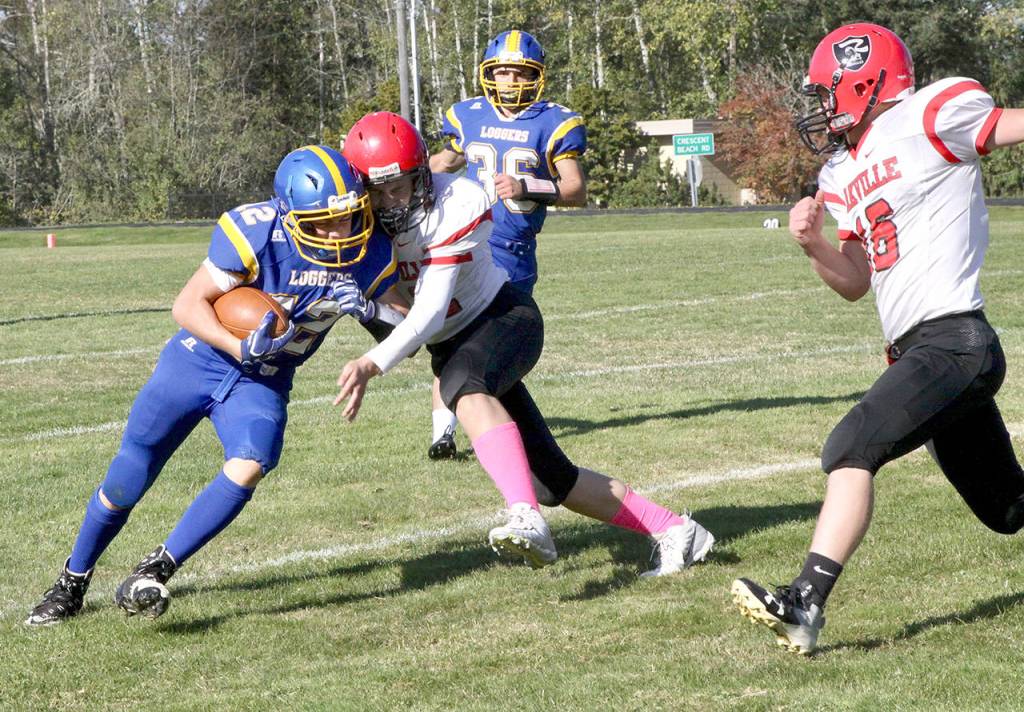 Crescents Wyatt Lee, left, delivers a blow while carrying the ball against Oakville last season. (Dave Logan/for Peninsula Daily News)