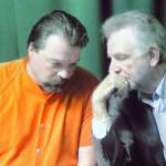 Matthew Timothy Wetherington, left, confers with public defender John Hayden on a video link to the courtroom during Wetheringtons arraignment in Clallam County Superior Court in Port Angeles. (Keith Thorpe/Peninsula Daily News)