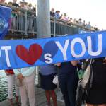 Carol Hasse presents a flag made and given to the crew of the Maiden. (Zach Jablonski/Peninsula Daily News)