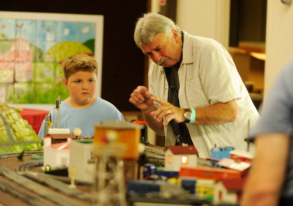 Nathaniel Baze, 7, at left, talks with Steve Dryke of the North Olympic Railroaders group at the Clallam County Fair. Michael Dashiell/Olympic Peninsula News Group