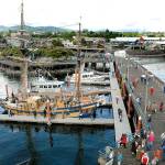 Visitors to the 2018 Port Angeles Maritime Festival make their way around City Pier to examine ships participating in the event, including the tall ship Hawaiian Chieftain, front. (Keith Thorpe/Peninsula Daily News)