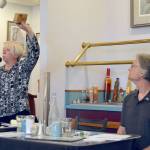 Port of Port Angeles Commissioner Connie Beauvais displays a block of thermally modified hemlock that the port is participating in developing during a general election forum Tuesday that included her challenger, Maury Modine. (Paul Gottlieb/Peninsula Daily News)
