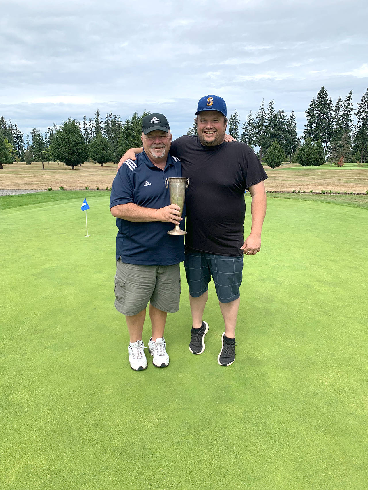 Peninsula Golf Clubs Paul Reed, left, teamed with his son Todd to win the clubs annual Member-Guest Tournament. The Reeds shot a gross 133 to beat Jade Tisdale and Curtis Rose and Jeremy Copeland and Sid Krump by seven strokes.                                Photo by: Peninsula Golf Club