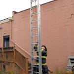 Port Angeles firefighter Chad Schoonhoven practices techniques to raise and lower a fire ladder during a drill at the former Harbor Art gallery on Railroad Avenue in downtown Port Angeles on Tuesday. (Keith Thorpe/Peninsula Daily News)