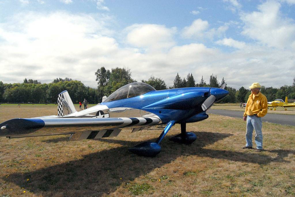 Forrest Davis of Sequim looks at a Vans Aircraft RV-4 parked on the tarmac during Saturdays Olympic Peninsula Air Affaire at Sequim Valley Airport. (Keith Thorpe/Peninsula Daily News)
