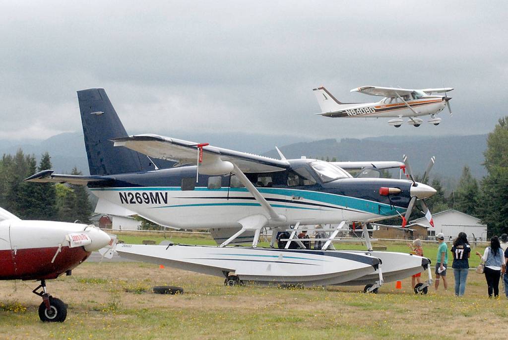 A Cessna 150 takes off from Sequim Valley Airport behind a float plane during Air Affaire at Sequim Valley Aiport on Saturday. (Keith Thorpe/Peninsula Daily News)