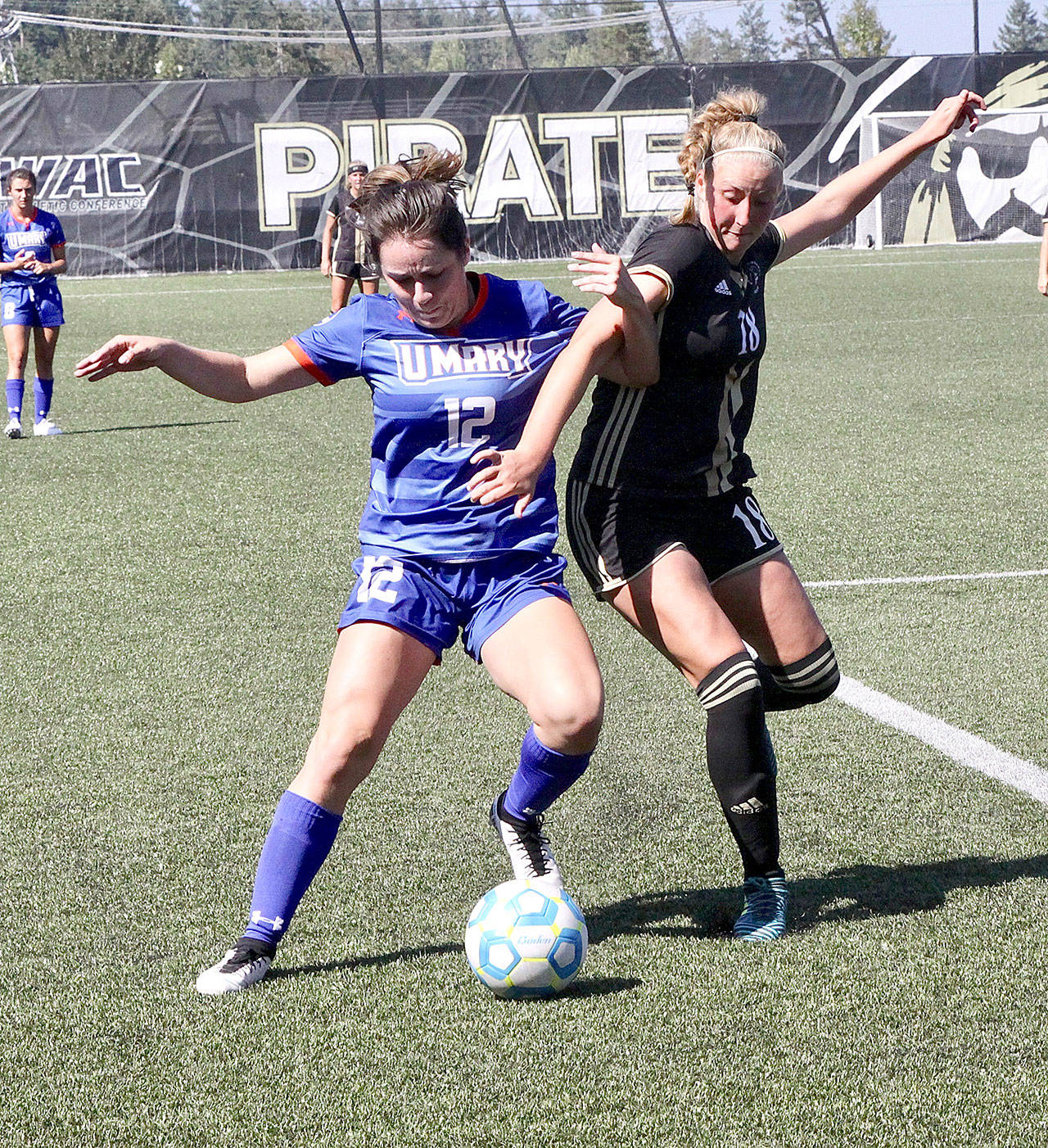 University of Marys Malia Brudvik (12) and Peninsula Colleges Kyrsten McGuffey (18) fight for the ball Monday at Wally Sigmar Field. Brudvik played for the Pirates back in 2016 when they won the NWAC championship and McGuffey is a Port Angeles High School graduate. (Dave Logan/for Peninsula Daily News )
