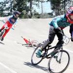 <strong>Dave Logan</strong>/for Peninsula Daily News                                Anthony Jones (25) of Port Angeles is in the lead over Peyton Calhoun (69) of Port Orchard while taking a spill is Jesse Campos of Tacoma who got up and finished the race. Jones limped home third at the Washington State BMX finals held Sunday at Lincoln Park. Jones won the 11 Cruiser race. More than 1,000 riders competed in races this weekend at Lincoln Park.