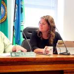 Jefferson County commissioners David Sullivan, left, and Kate Dean deliberate with Commissioner Greg Brotherton and County Administrator Philip Morley on the letter the board plans to send to Pope Resources and other government agencies regarding the recent aerial spraying of herbicides. (Brian McLean/Peninsula Daily News)