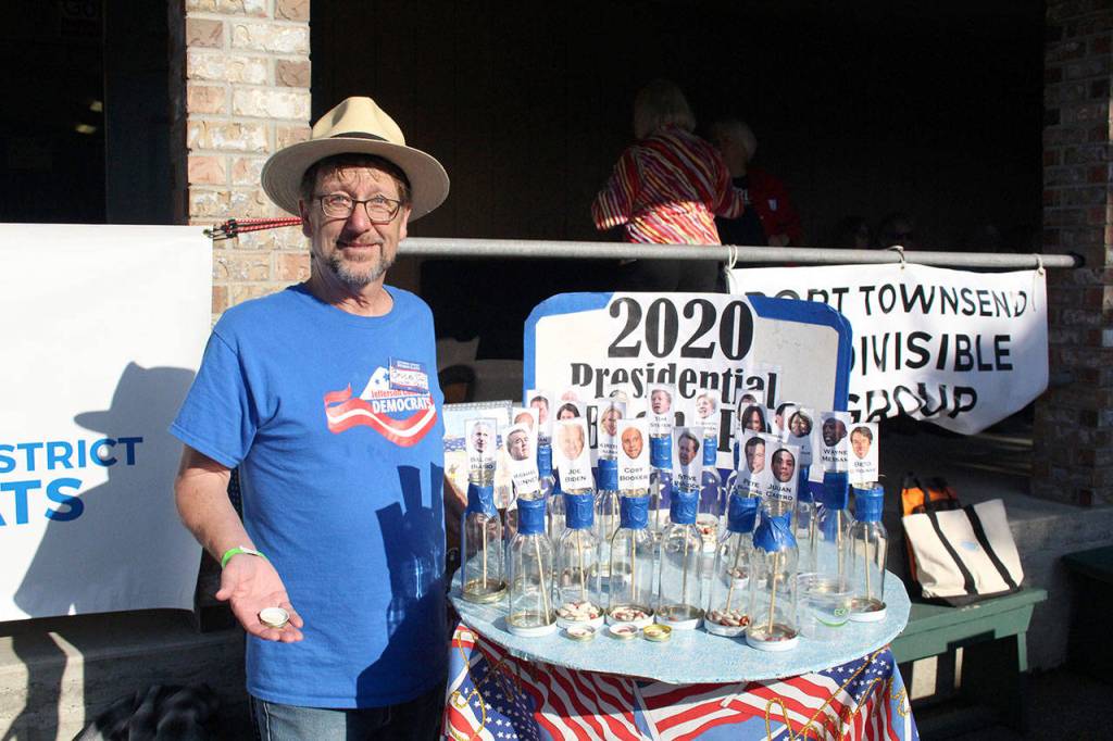 Democratic Precinct Committee Chair Bruce Cowan stands with a bean count election that let attendees vote for who their first, second, and third choice of Democratic candidate for president. Candidate Elizabeth Warren won with 49 first-choice votes. (Zach Jablonski/Peninsula Daily News)